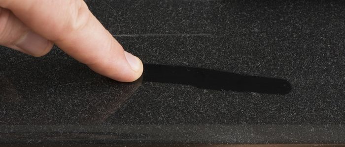 Using a finger to clean dust off a piano